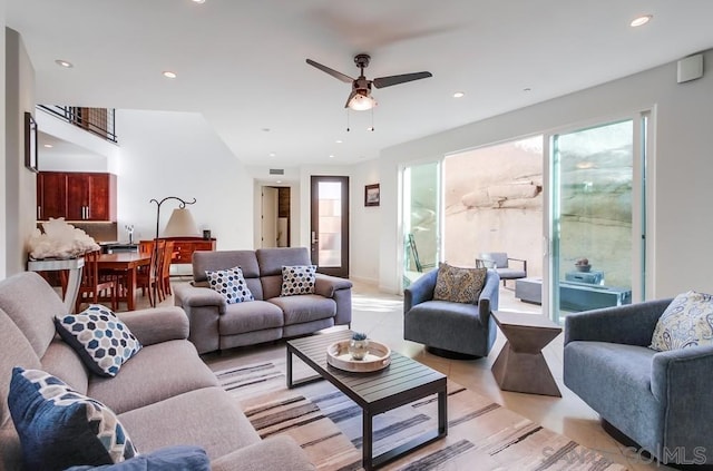 living room with ceiling fan, a healthy amount of sunlight, and light tile patterned floors