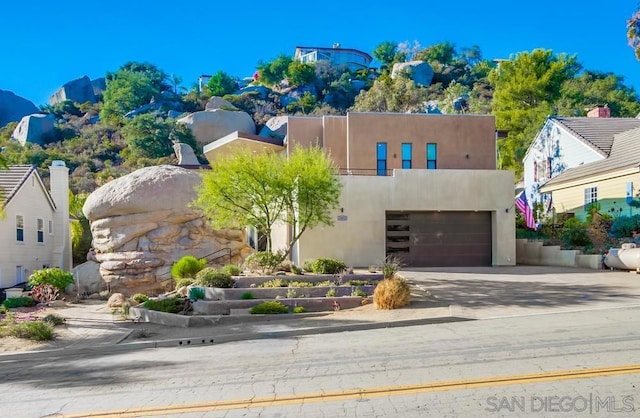 pueblo revival-style home featuring a mountain view and a garage