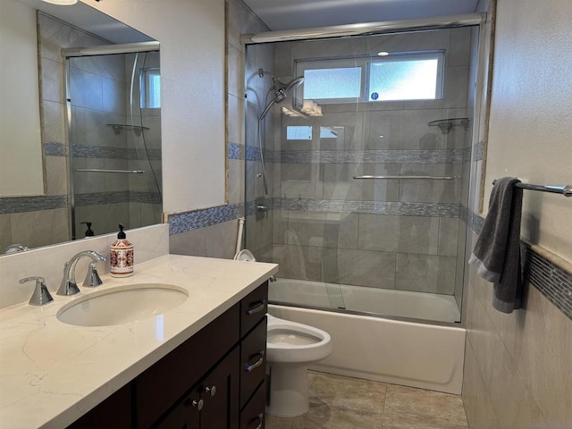 full bathroom with vanity, toilet, and bath / shower combo with glass door