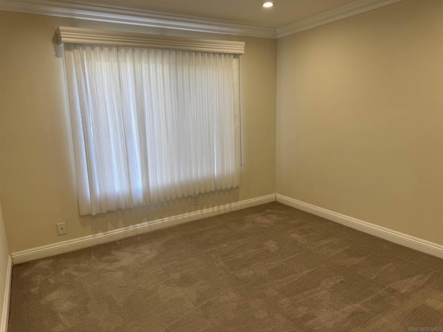 unfurnished room with dark carpet and crown molding