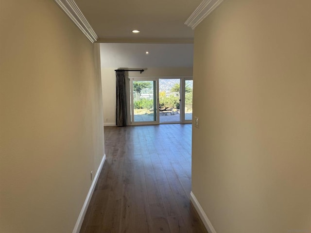 hallway with wood-type flooring and ornamental molding