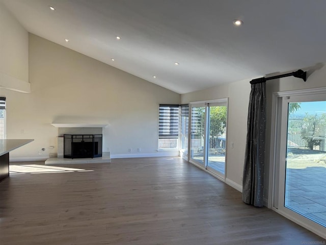 unfurnished living room featuring hardwood / wood-style flooring and high vaulted ceiling