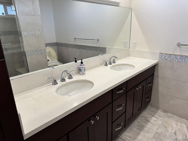 bathroom featuring vanity and tile walls