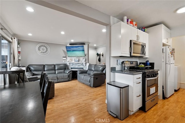 kitchen featuring white cabinetry, light wood-type flooring, and stainless steel appliances