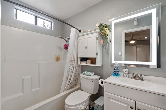 full bathroom featuring shower / bath combination with curtain, ceiling fan, toilet, and vanity