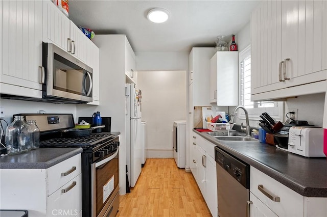 kitchen featuring white cabinetry, light wood-type flooring, sink, and appliances with stainless steel finishes