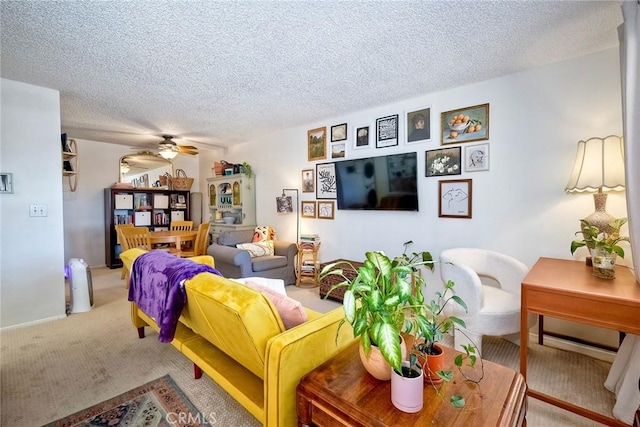 carpeted living room with ceiling fan and a textured ceiling