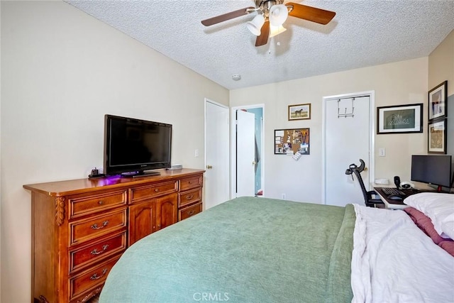 bedroom with ceiling fan and a textured ceiling