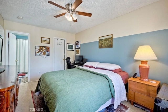 bedroom with a textured ceiling and ceiling fan