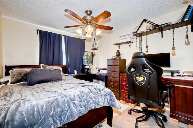 bedroom featuring ceiling fan and a textured ceiling