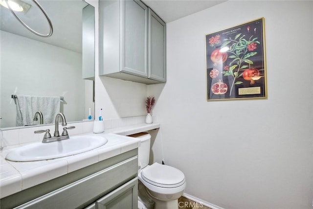 bathroom featuring toilet and vanity