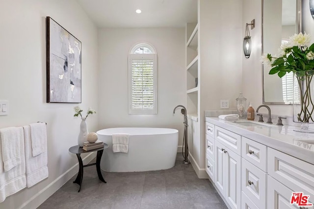 bathroom featuring vanity and a tub