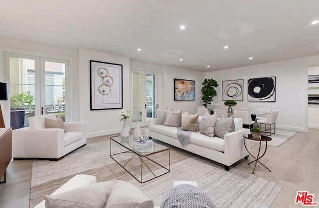 living room with french doors and light hardwood / wood-style flooring