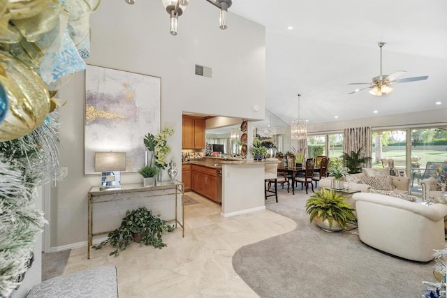 living room with ceiling fan with notable chandelier and high vaulted ceiling