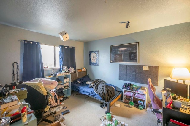 carpeted bedroom featuring a textured ceiling