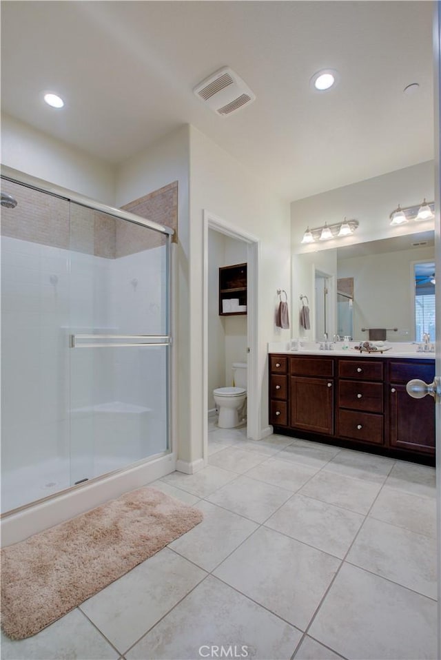 full bath with visible vents, toilet, a shower stall, vanity, and tile patterned floors