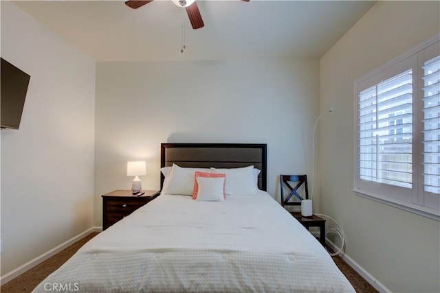 bedroom featuring dark carpet, a ceiling fan, and baseboards