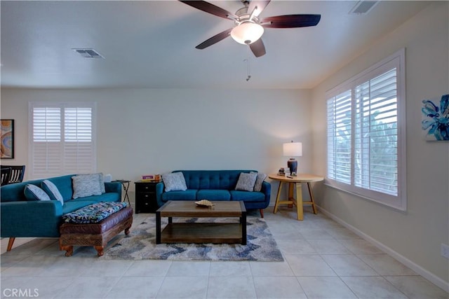 living area featuring visible vents, baseboards, and light tile patterned floors