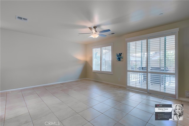 spare room with ceiling fan and light tile patterned flooring