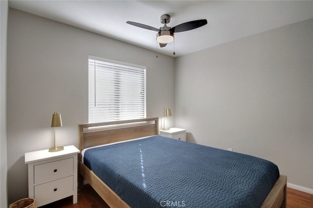 bedroom with ceiling fan and dark wood-type flooring