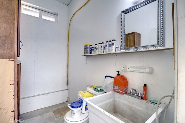 bathroom with concrete flooring and sink