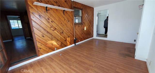 interior space with wooden walls and hardwood / wood-style flooring