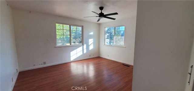 unfurnished room with dark hardwood / wood-style floors and ceiling fan