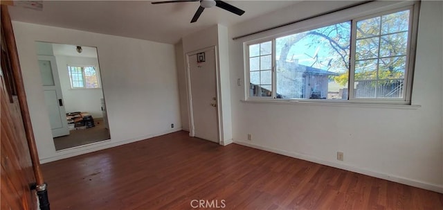 unfurnished room featuring ceiling fan and dark wood-type flooring