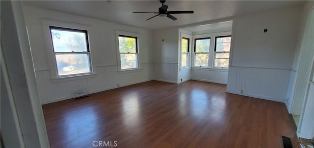 spare room featuring wood-type flooring and ceiling fan