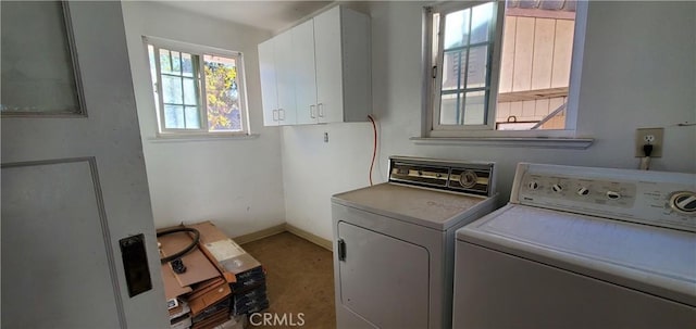 washroom featuring cabinets and washer and dryer