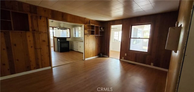 interior space with wooden walls and hardwood / wood-style floors