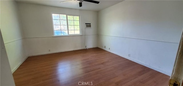 unfurnished room featuring wood finished floors, a ceiling fan, and a wall mounted AC