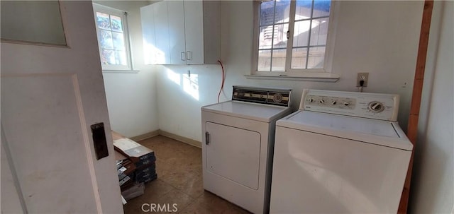 clothes washing area featuring baseboards, laundry area, and washing machine and clothes dryer