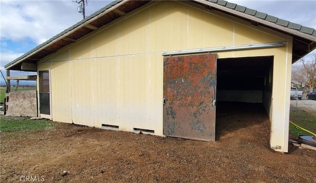 view of side of home with an outbuilding