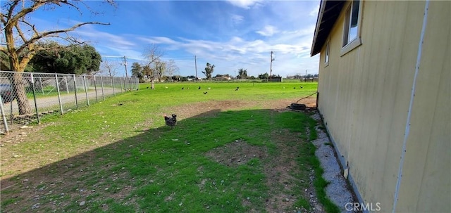view of yard featuring a rural view and fence