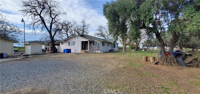 back of house featuring driveway