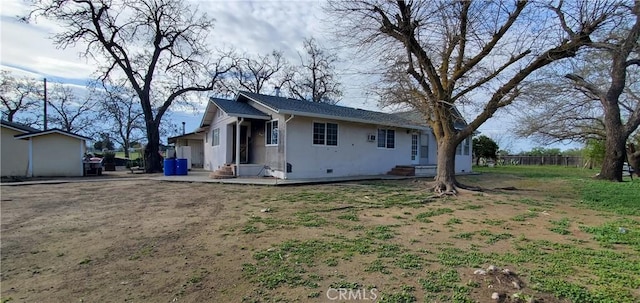 back of property featuring stucco siding and fence