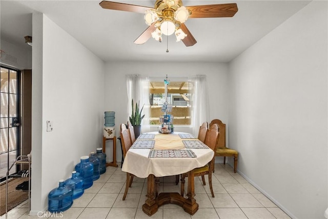 tiled dining space with ceiling fan