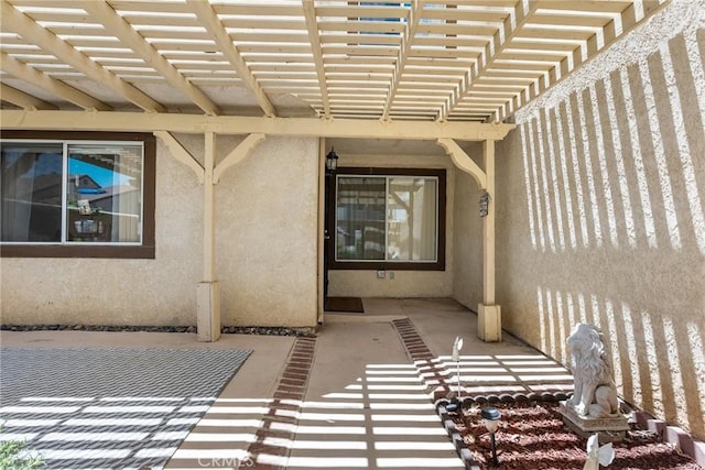 doorway to property featuring a pergola