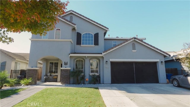 view of front of property featuring a garage and a front yard