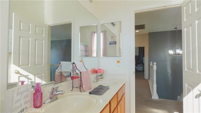 bathroom featuring vanity and an inviting chandelier