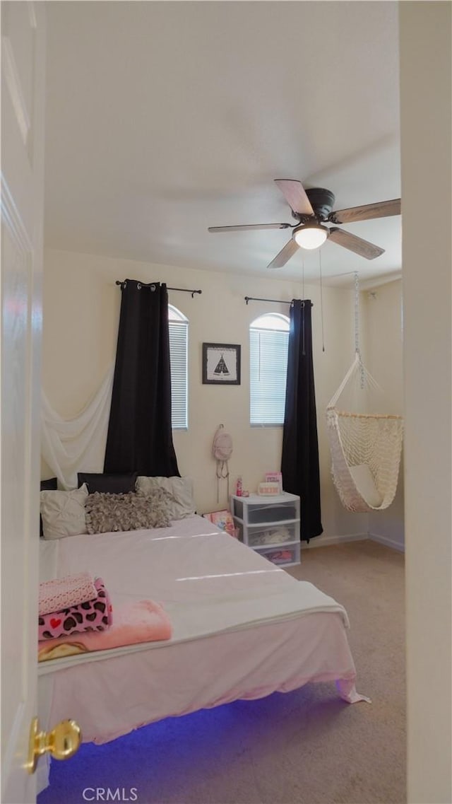 carpeted bedroom with ceiling fan