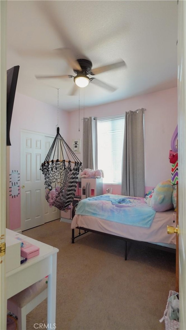 carpeted bedroom featuring ceiling fan