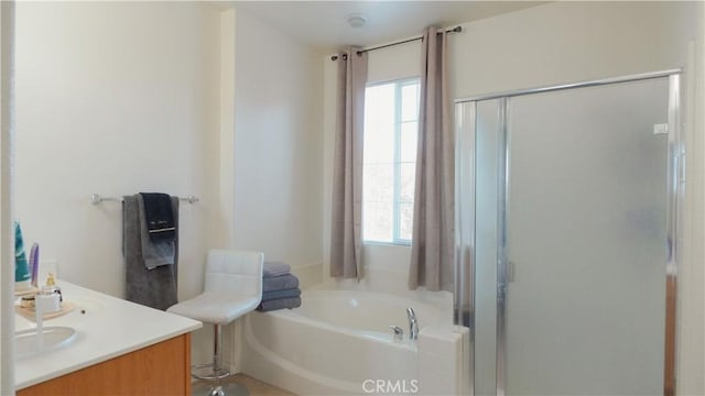 bathroom featuring shower with separate bathtub and vanity