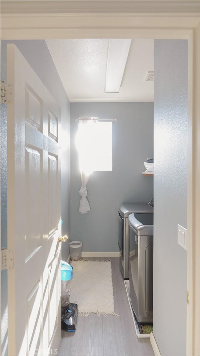 washroom featuring washer and dryer and a wealth of natural light