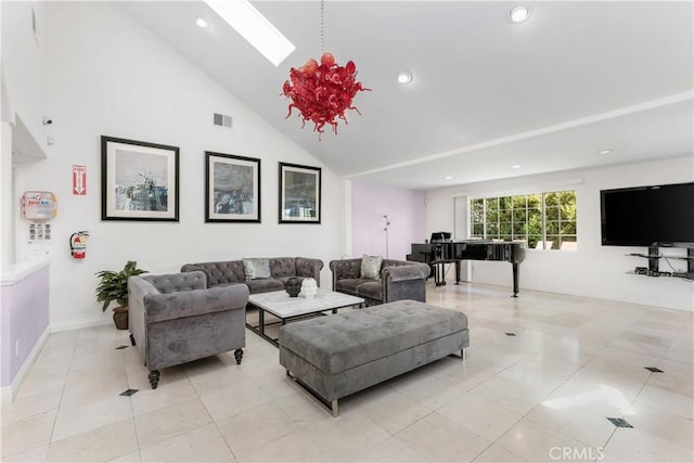 living room with a skylight, high vaulted ceiling, and light tile patterned flooring