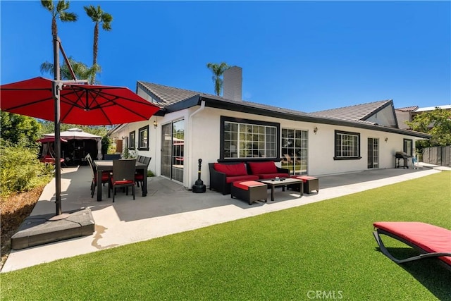 rear view of property featuring an outdoor living space, a yard, and a patio