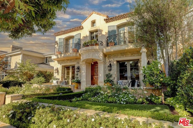 mediterranean / spanish home featuring a balcony