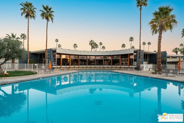 view of pool at dusk