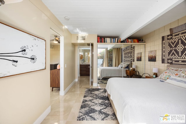 bedroom with tile walls